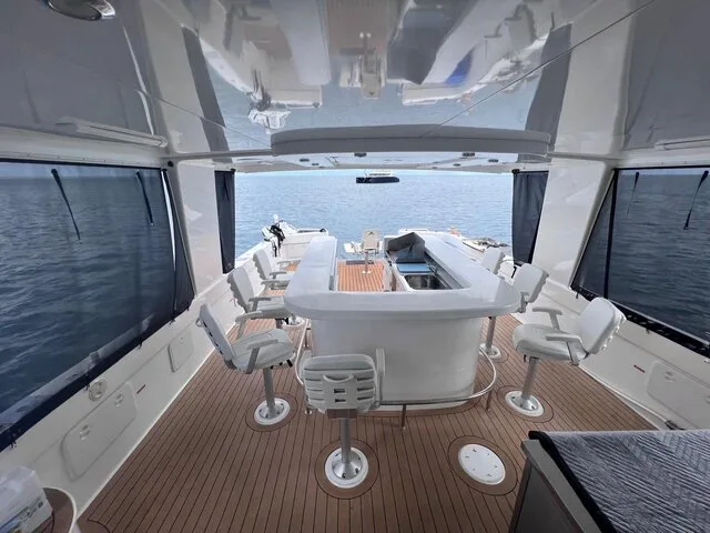 Spacious interior of a luxury fishing boat featuring modern seating and a clean helm area, ideal for a comfortable fishing experience.